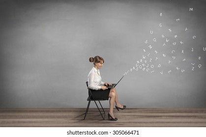 woman sitting on chair and holding laptop - Powered by Shutterstock