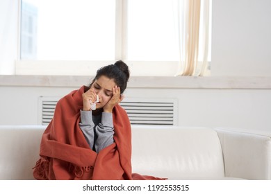 woman sitting on the couch                                - Shutterstock ID 1192553515