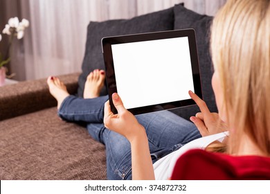 Woman Sitting On Couch And Using Tablet 