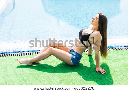 Similar – Brunette surfer woman with top and bikini holding surfboard