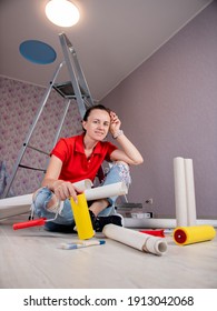 A Woman Is Sitting On The Floor And Clutching Her Head From The Volume Of Work Of The Upcoming Renovation In The Apartment.