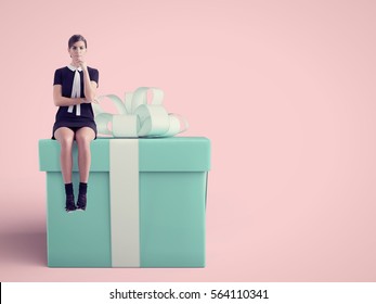 Woman Sitting On Huge Present In Studio