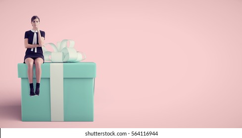 Woman Sitting On Huge Present In Studio