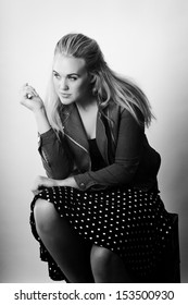 Woman Sitting On Milk Crates Shot In The Studio On White Background