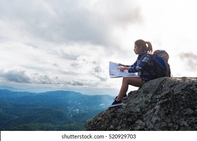  Woman Sitting On Mountain And Open A Map,adventure Travel, Vintage Effect Tone.