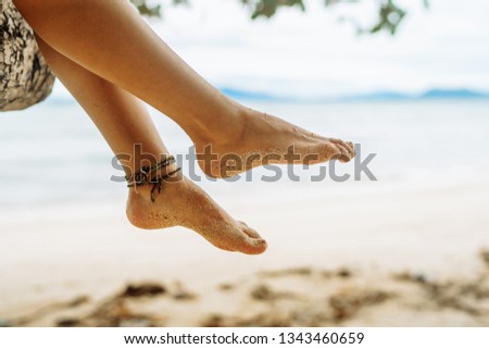 Woman sitting on palm tree at tropical beach. Philippines