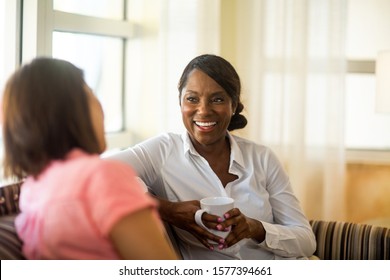 Woman sitting on a sofa talking. - Shutterstock ID 1577394661