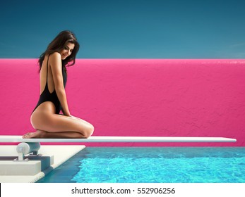 Woman Sitting On Springboard At The Pool