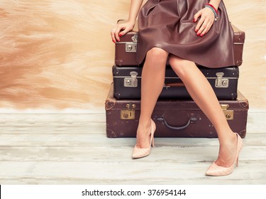 Woman sitting on suitcases 