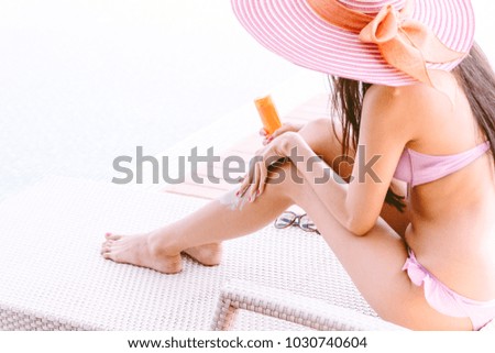 Similar – Woman applying sunscreen by the pool during summer