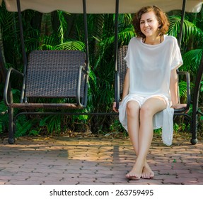 Woman Sitting On The Swingset