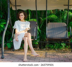 Woman Sitting On The Swingset