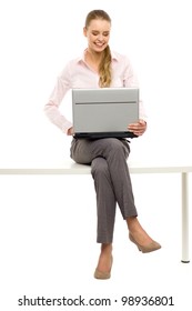 Woman Sitting On Table With Laptop