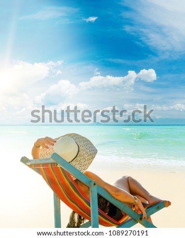 Woman sitting on the wild beach of the island of Lefkada in Greece 