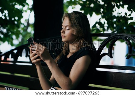 Similar – Woman with earphones listening music in smartphone