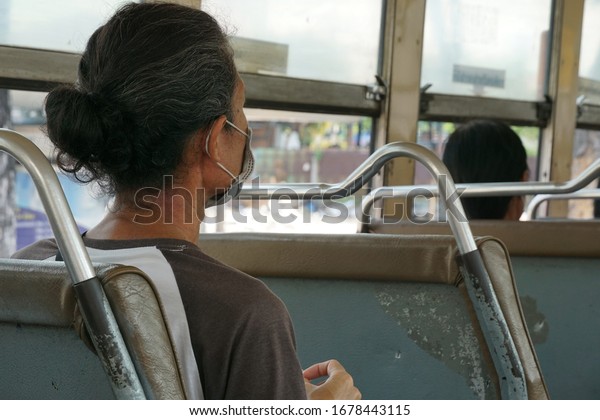   Woman sitting in public bus,wearing face masks and
keeping social distancing to stop spreading,outbreak coronavirus
covid-19 for health safety, personal crisis management.            
              