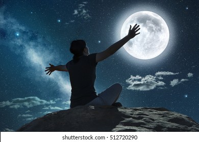 Woman Sitting And Raising Arms In The Moonlight 