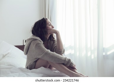 Woman sitting relaxed in bed