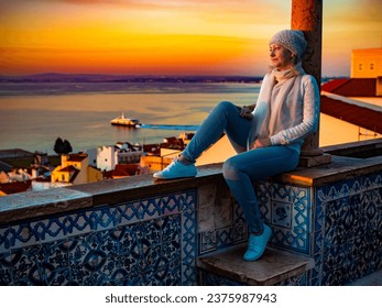 Woman sitting at Santa Luzia viewpoint in Lisbon