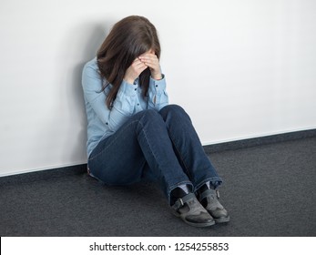 Woman sitting strain unhappy in a room