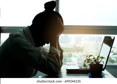 Woman sitting stressed not happy at her desk. Health concept