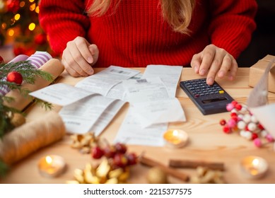Woman sitting at the table, checking her bills after buying everything for Christmas. Winter holidays shopping, expensive time of the year