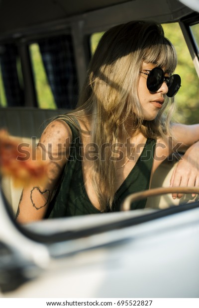Woman Sitting\
Thoughtful in a Van Road\
Trip