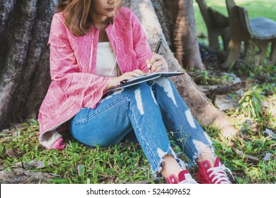 Woman Sitting Under The Tree And Writing Note,Checklist Notice Remember Planning Concept