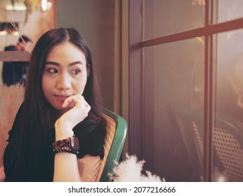 Woman Sitting Vacant And Lookink At The Window.