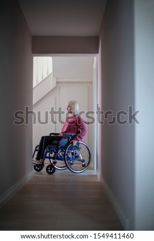 Similar – Caregiver with elderly patient in a wheelchair in front of window