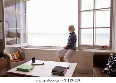 Woman Sitting At Window And Looking At Beautiful Beach View - Powered by Shutterstock