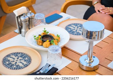 Woman Sitting Wooden Dinner Table At A Luxury Restaurant And Eating Ravioli