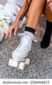 Woman skating in city. Girl going rollerblading sitting in the floor - Shutterstock ID 2366468617