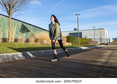 Woman skating - rollerblading in a modern area.