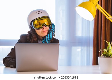 Woman In Ski Equipment Working On Laptop In Office Dreaming About Winter Vacation