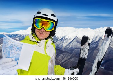 Woman With Ski Track Map On The Mountain