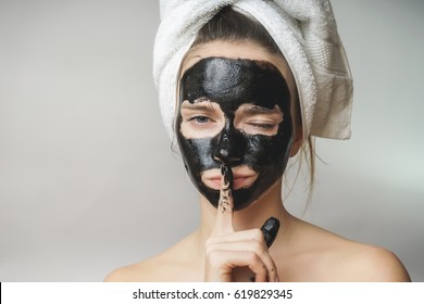 Woman Skin Care,cosmetics Black Mask On Face.Towel On Head