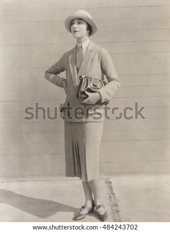 Woman in skirt suit carrying handbag