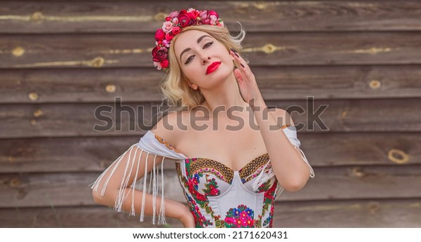 Woman in Slavic ethnic\
embroidered dress, flower wreath in hair. Concept of beauty Slavic\
women, Boho style