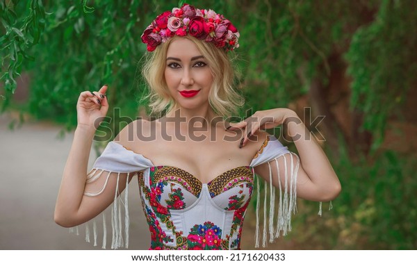 Woman in Slavic ethnic\
embroidered dress, flower wreath in hair. Concept of beauty Slavic\
women, Boho style
