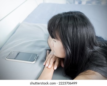 Woman Sleep In Bed Room And Looking Mobile In Night At Home,Girl Talking To Couple Husband Family With Sad And Stressed,Lonely,Unhappy Broken Heart And Problem,Authentic Black Hair And Skin Tan Asian.