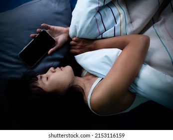 Woman Sleep And Holding Mobile On The Bed In Night At Room.couple Married Wait Husband Call Back.she Face Sad And Lonely. Card Poster For Broken Heart, Love Valentine Day, Break My Heart,pain Concept.