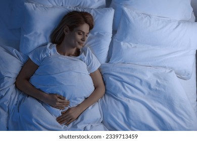 Woman sleeping in bed at night, above view. Space for text - Powered by Shutterstock
