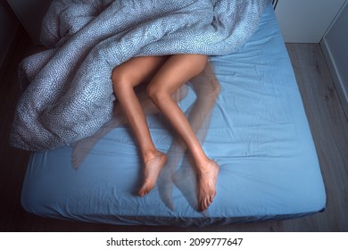 Woman sleeping in the bed and suffering from RLS or restless legs syndrome