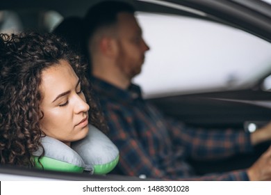 Woman Sleeping In A Car On A Car Pillow