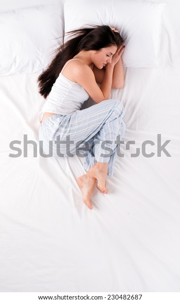 Woman sleeping in fetal\
position