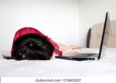 Woman sleeping near the laptop at home, sick girl in red nightie lying on a bed. Concept of tired after work, lazy day, freelancer - Shutterstock ID 1718455207