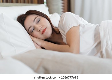 woman sleeping on a bed in bedroom
