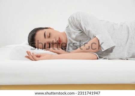 Woman sleeping on memory foam pillow indoors