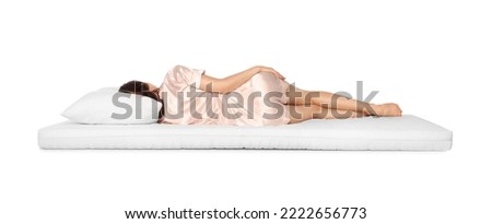Woman sleeping on soft mattress against white background, back view